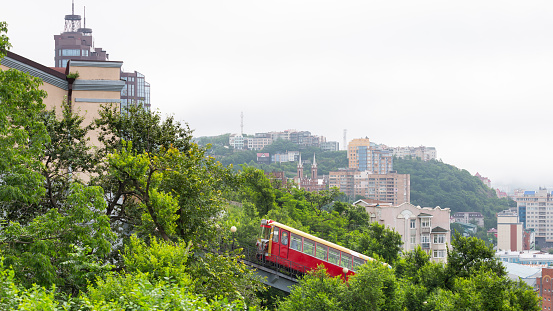 Vladivostok, Russia - July 26, 2022: The red funicular wagon is going up in Vladivostok, Primorsky Krai, Russia