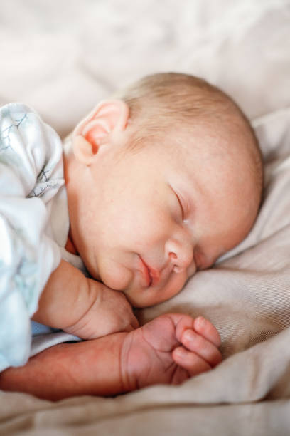 istock Little newborn baby boy sleeping in the bed 1496967500