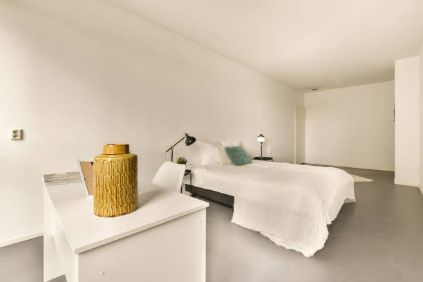istock a bedroom with a large bed and a white counter 1496969629