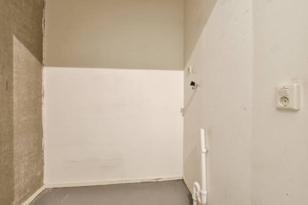 istock an empty room with a white wall and a door 1496969651