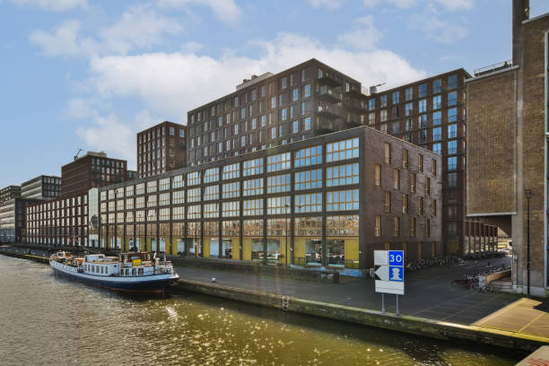 istock a large building next to a river with a boat 1496969672