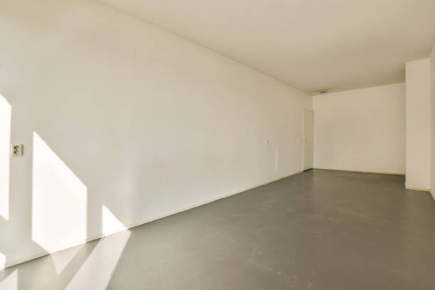 istock an empty room with white walls and a concrete floor 1496969702
