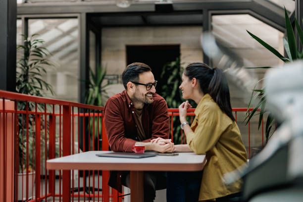 istock Two lovers, working together, at the office, holding hands, looking at each other. 1496969812