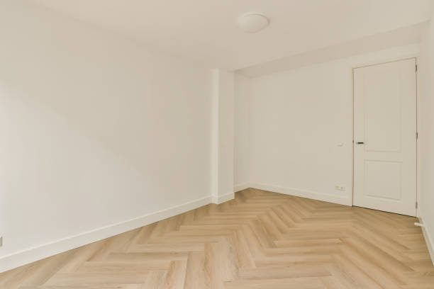 istock a room with white walls and a wooden floor 1496970595