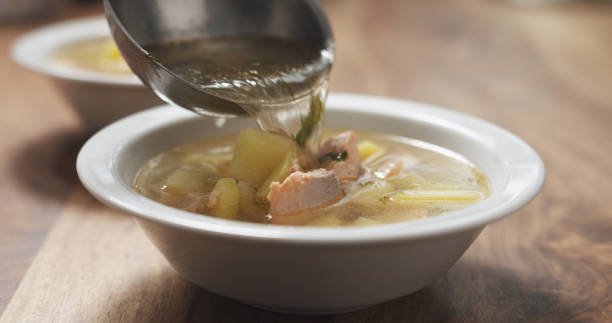 istock closeup pour fish soup with salmon into bowl 1496971025