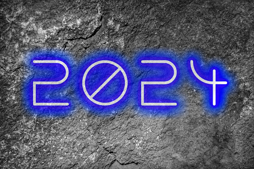The date 2024 in glowing numbers on a textured background for New Years.
