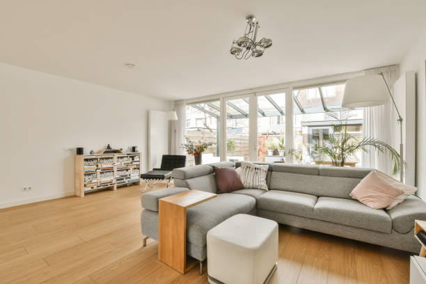 istock a living room with a gray couch and a window 1496974893