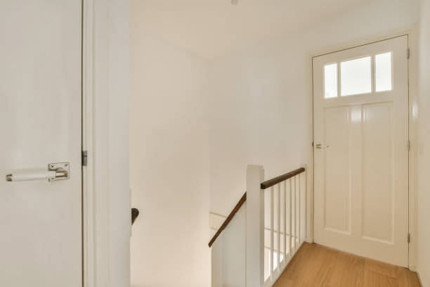istock a white room with a staircase and a white door 1496974948