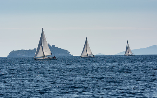 Bodrum,Turkey. 08 October 2023: Sailboats sail in windy weather in the blue waters of the Aegean Sea, on the shores of the famous holiday destination Bodrum.