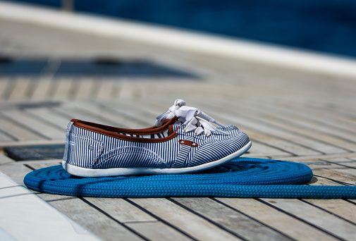 Shoes on board a striped yacht.