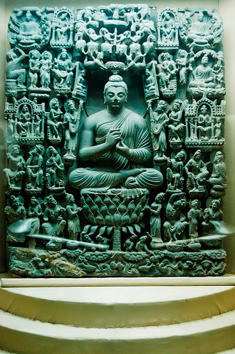 Pakistan, Lahore - March 27, 2005: A Buddha statue and Buddhist figures around it in Lahore Museum