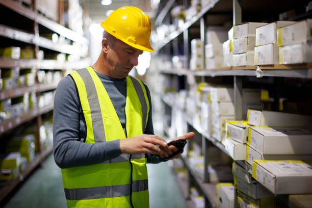 Warehouse worker scanning boxes with bar code scanner Warehouse worker scanning boxes with bar code scanner bar code reader radio frequency identification warehouse checklist stock pictures, royalty-free photos & images