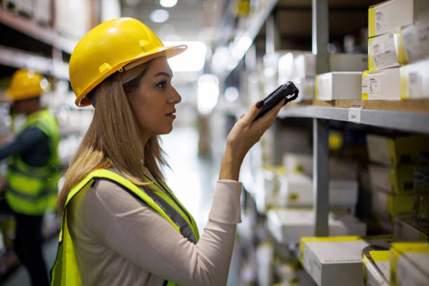 Warehouse worker scanning boxes with bar code scanner Warehouse worker scanning boxes with bar code scanner bar code reader radio frequency identification warehouse checklist stock pictures, royalty-free photos & images