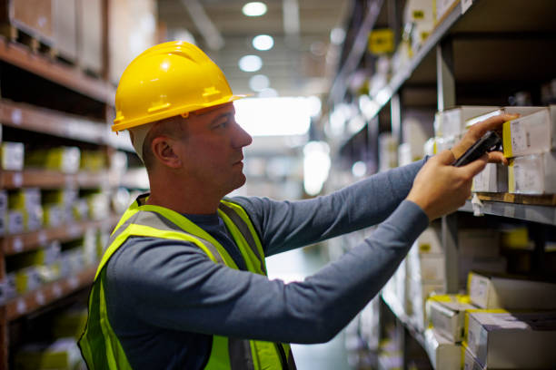 Warehouse worker scanning boxes with bar code scanner Warehouse worker scanning boxes with bar code scanner bar code reader radio frequency identification warehouse checklist stock pictures, royalty-free photos & images