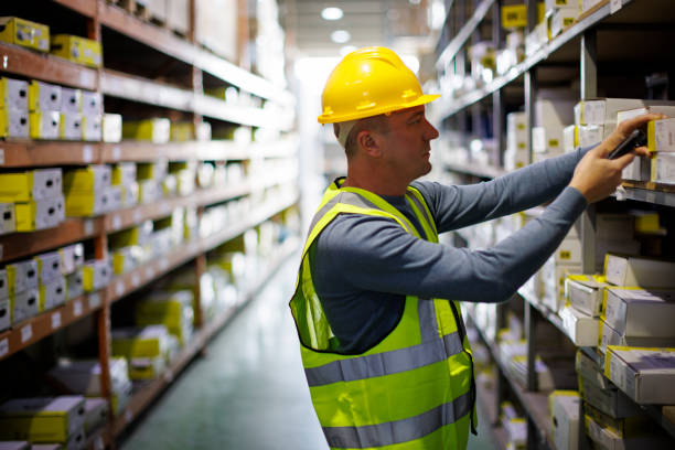 Warehouse worker scanning boxes with bar code scanner Warehouse worker scanning boxes with bar code scanner bar code reader radio frequency identification warehouse checklist stock pictures, royalty-free photos & images