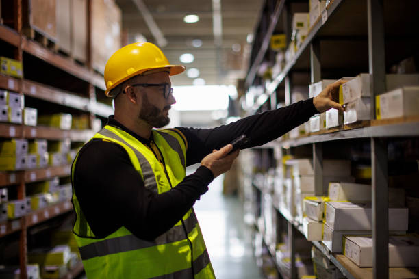 Warehouse worker scanning boxes with bar code scanner Warehouse worker scanning boxes with bar code scanner bar code reader radio frequency identification warehouse checklist stock pictures, royalty-free photos & images