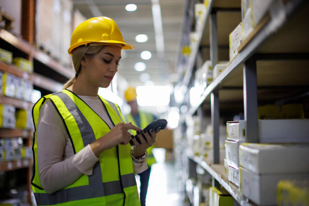 Female warehouse worker scanning boxes with bar code scanner Female warehouse worker scanning boxes with bar code scanner bar code reader radio frequency identification warehouse checklist stock pictures, royalty-free photos & images