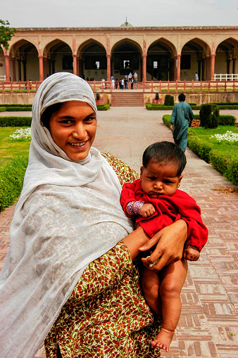 Pakistan, Lahor - March 27, 2005 : A young Pakistani mother holding her baby in her arms