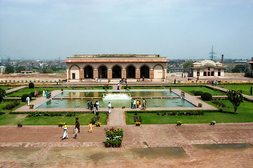 Pakistan, Lahor - March 27, 2005 : Badshahi Mosque looking over gardens in Lahore Pakistan and garden with pool.