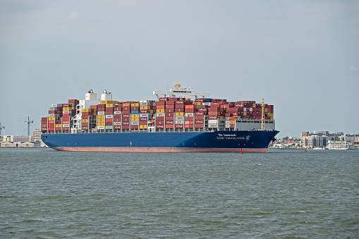 Charleston, SC, USA - June 06, 2023: Thailand, a 333-meter container ship owned by ZIM Integrated Shipping Services and flagged to Thailand, sails into Charleston Harbor.
