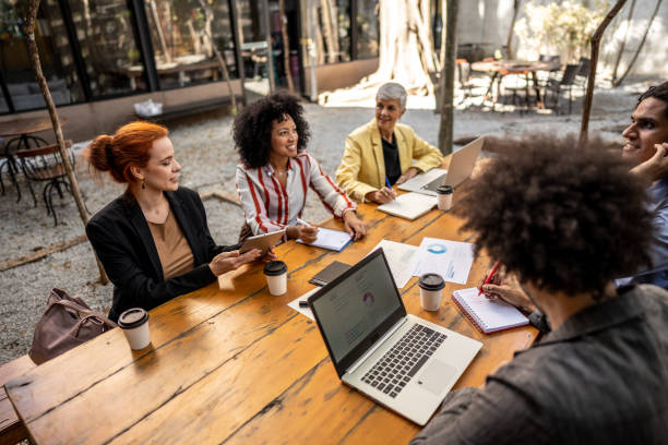 Coworkers talking during a meeting at outdoors office