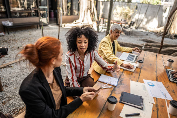 istock Businesswomen using digital tablet during a meeting at office 1496986649