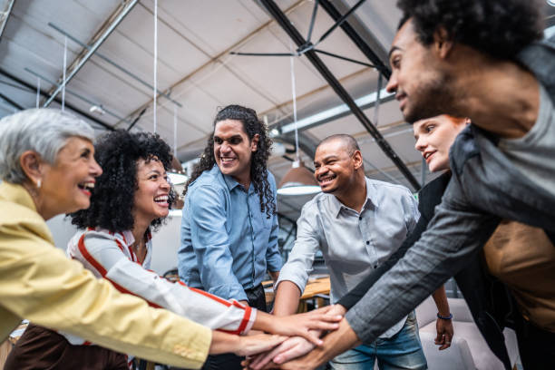 istock Coworkers with stacked hands at office 1496988552