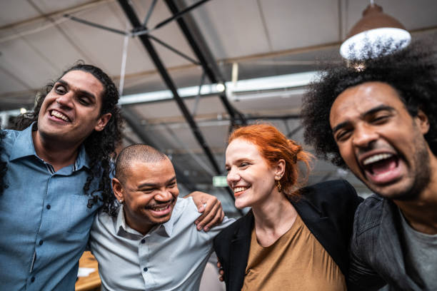 istock Coworkers embracing and celebrating at office 1496988582