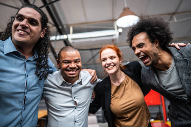 istock Coworkers embracing and celebrating at office 1496988617