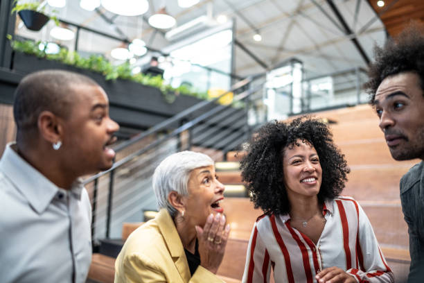 istock Happy coworkers talking at office 1496989470