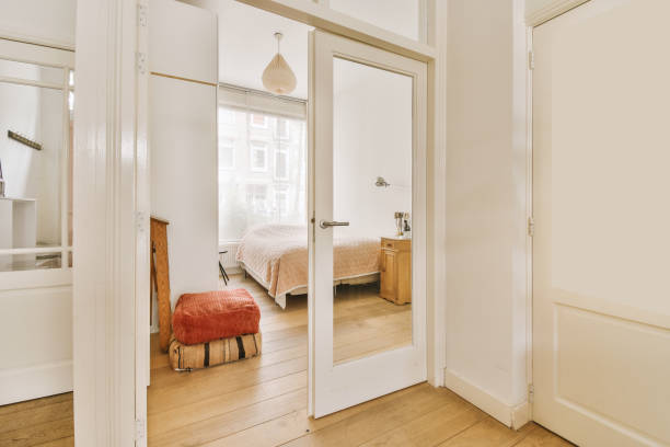 istock a bedroom with a bed and a door to a 1496989514