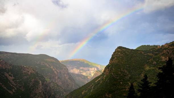 istock there is a rainbow over a mountain area with some trees 1496992187