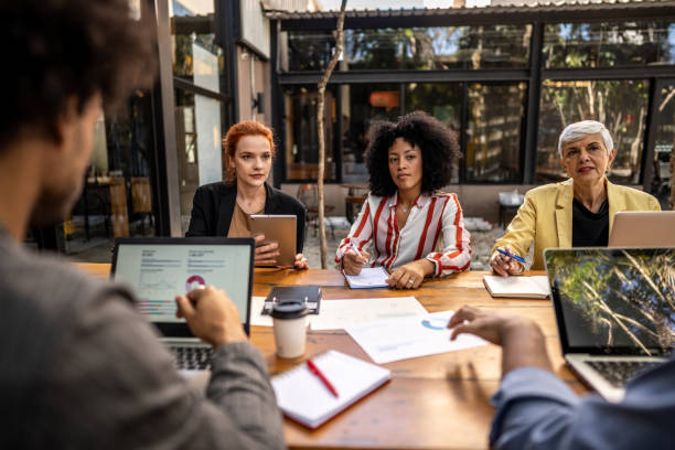 istock Coworkers talking during a meeting at outdoors office 1496992879