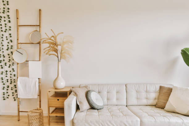istock a living room with a white couch and a plant 1496993677