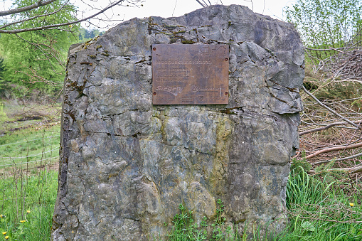 mile stone with a brass badge, marking the center Siegen Wittgenstein in the Rothaarsteig mountains.