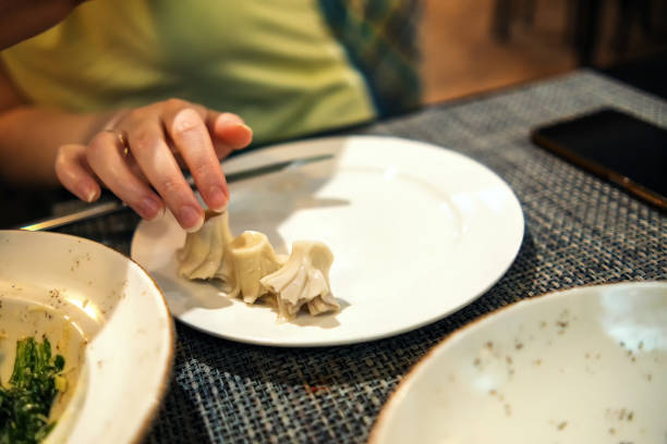 Leftover khinkali on a plate in front of a girl