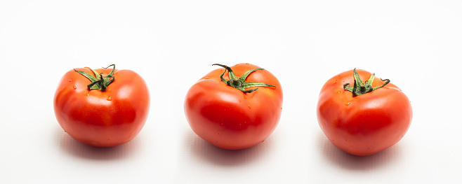 Goiania, Goias, Brazil – June 08, 2023:  Three beautiful, ripe, red tomatoes on a white background.
