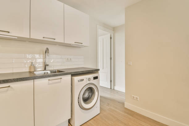istock a white kitchen with a washing machine and a sink 1496998944