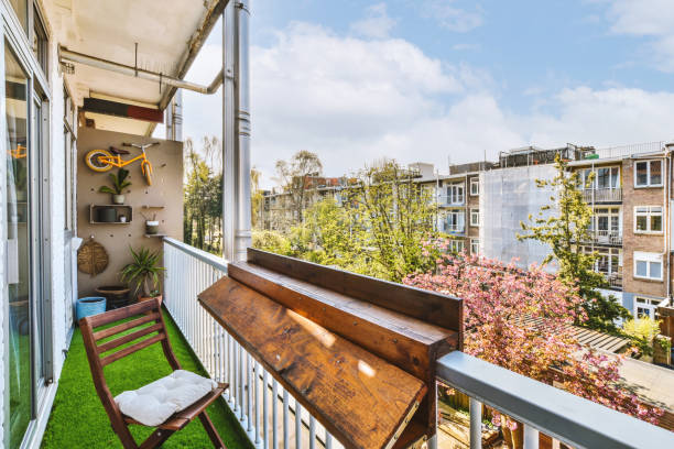 istock a balcony with a wooden bench and a city view 1497000727