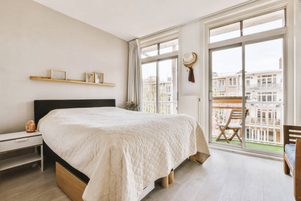 istock a bedroom with a bed and a large window 1497000730