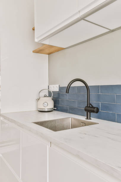 istock a kitchen sink with black faucet and blue 1497000755