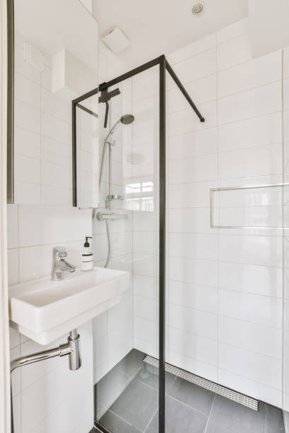 istock a white bathroom with a shower and a sink 1497000758