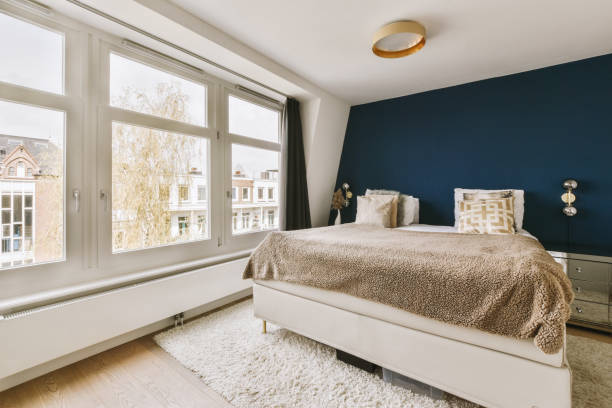 istock a bedroom with a bed and a blue accent wall 1497000985