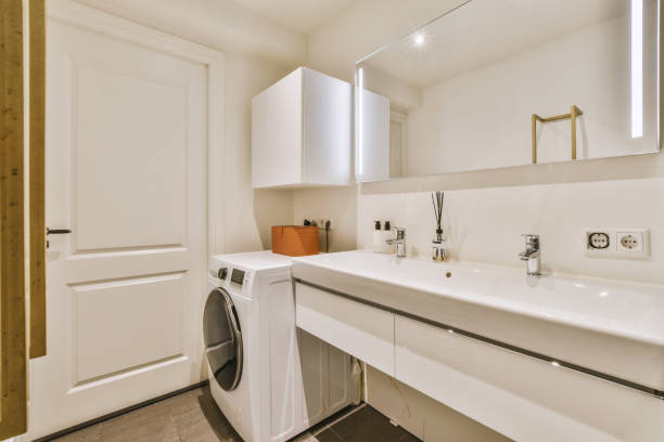 istock a laundry room with a sink and a washing machine 1497001004