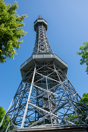 Petrin lookout tower in Prague, Czech Republic on a hill in a park in the center of the city.