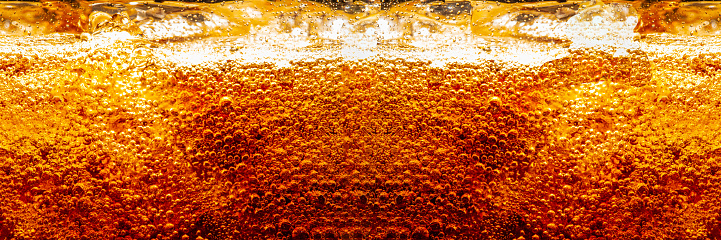 cola texture,Cola and Ice, food background, Cola close-up, design element. Beer. Macro bubbles, ice, bubbles, background, ice cubes, abstract background.