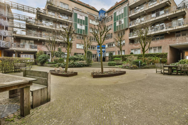 istock an open courtyard with benches and trees in the middle 1497003764