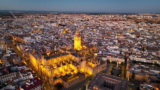 4k Aerial shot of Seville with gothic cathedral and famous Giralda bell tower. Seville, Spain.