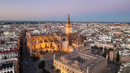 4k Aerial shot of Seville with gothic cathedral and famous Giralda bell tower. Seville, Spain.