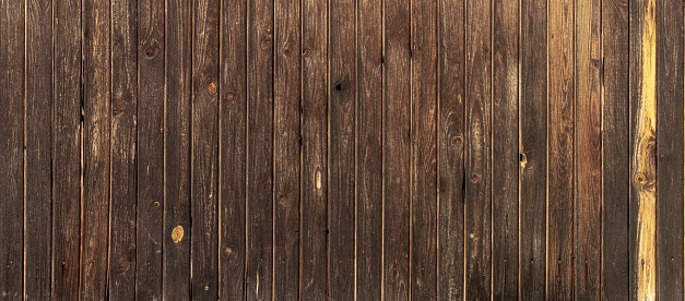 Dark, high-resolution background. Vertical brown boards without gaps